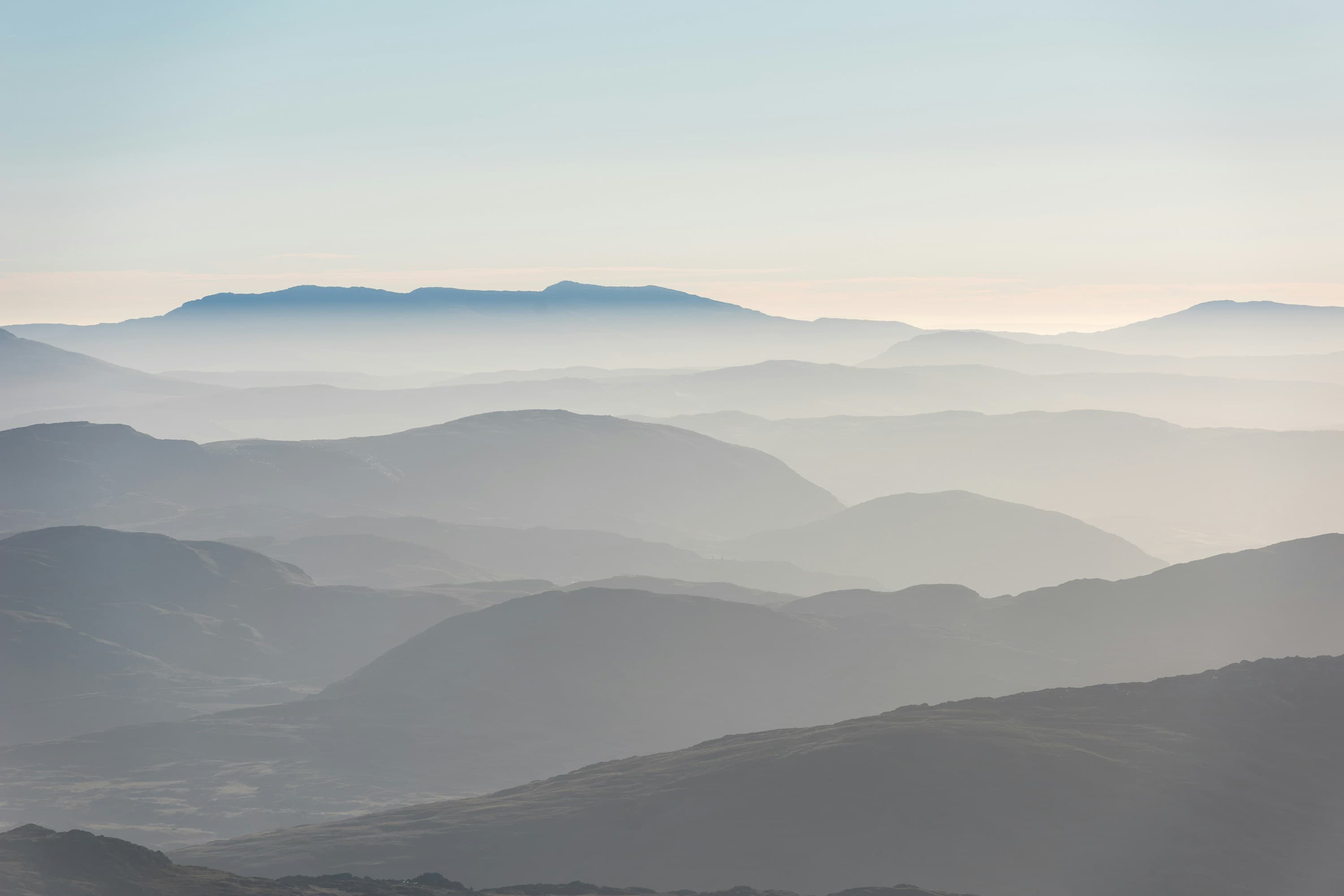 Layered mountains at sunrise